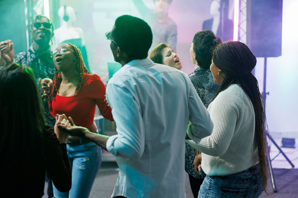 diverse-people-clubbing-dancing-together-discotheque-party-event-nightclub-young-friends-holding-hands-singing-relaxing-crowded-dancefloor-social-gathering_482257-67151